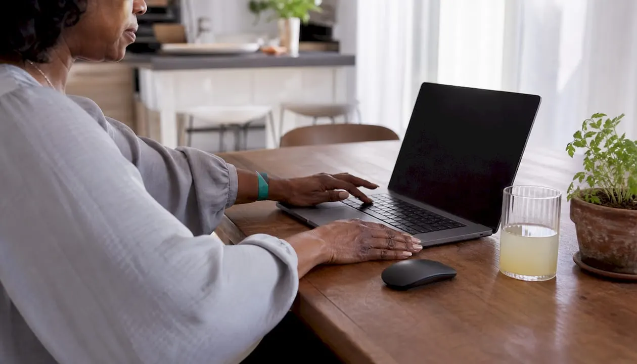 Close-up of hands on reseller application form laptop